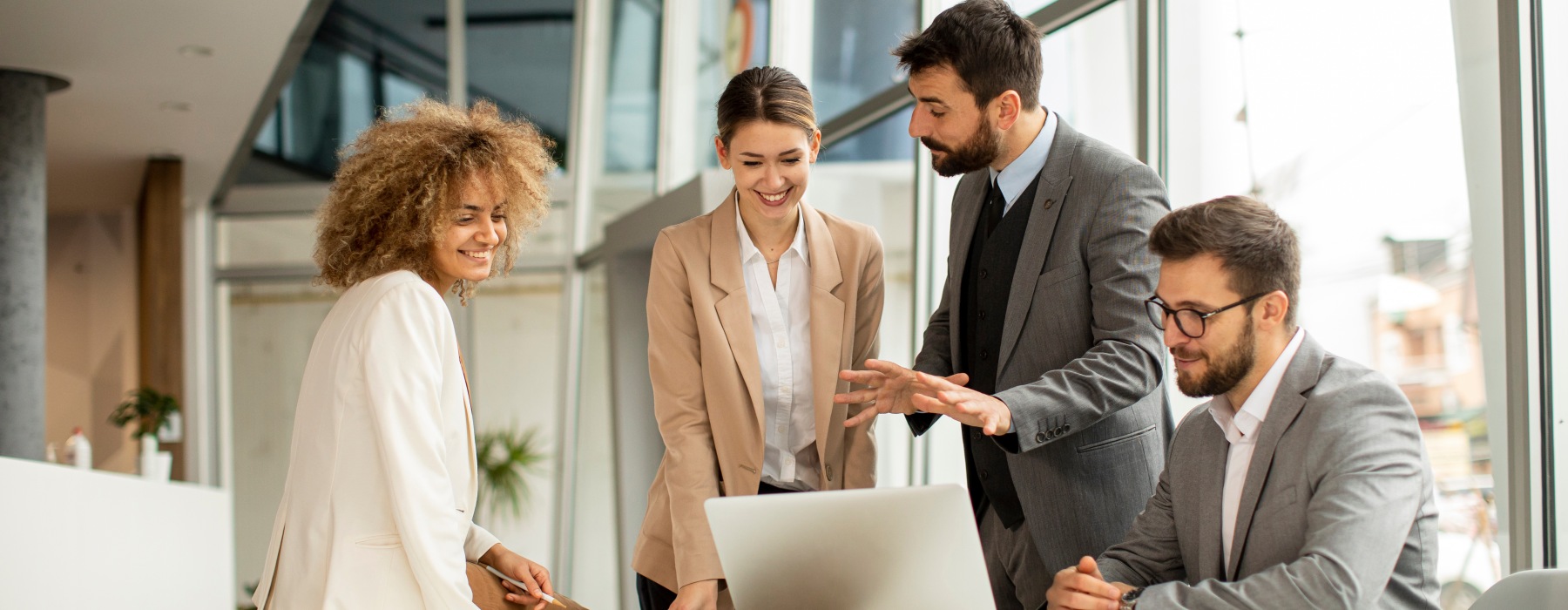 Stock photo of group at table looking at laptop