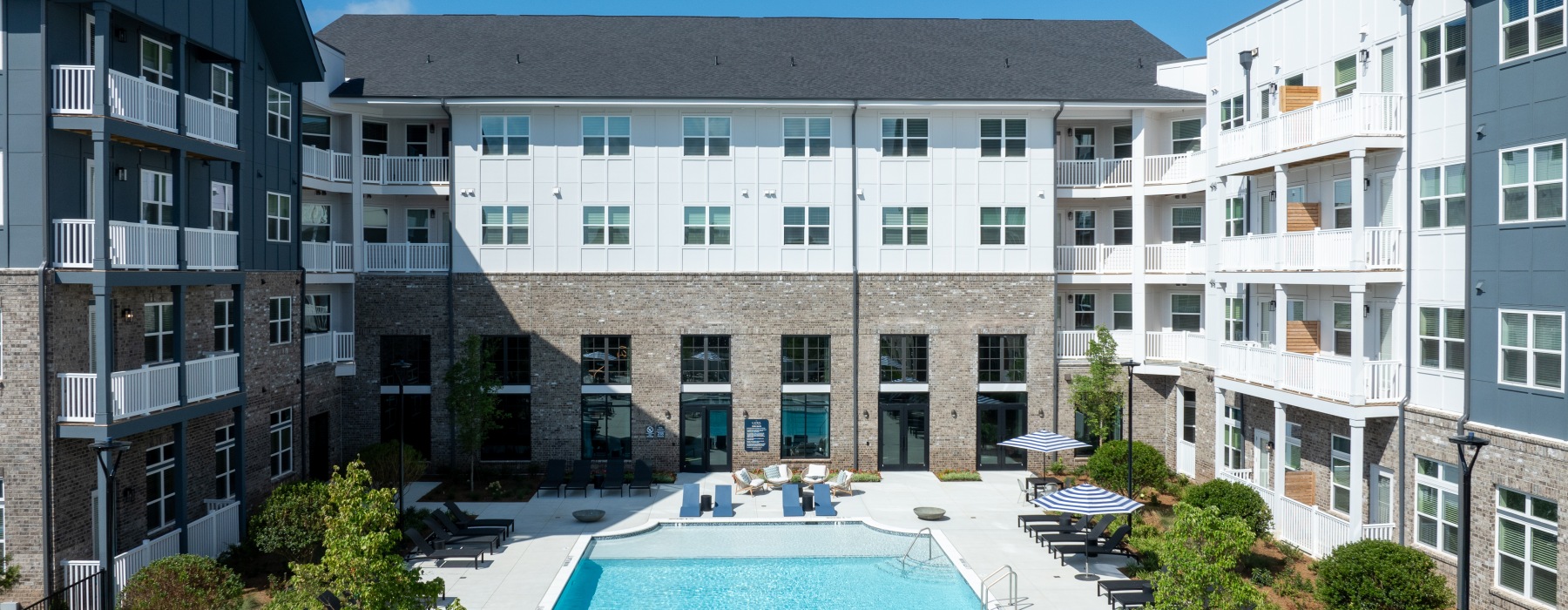 a swimming pool in front of the apartment building