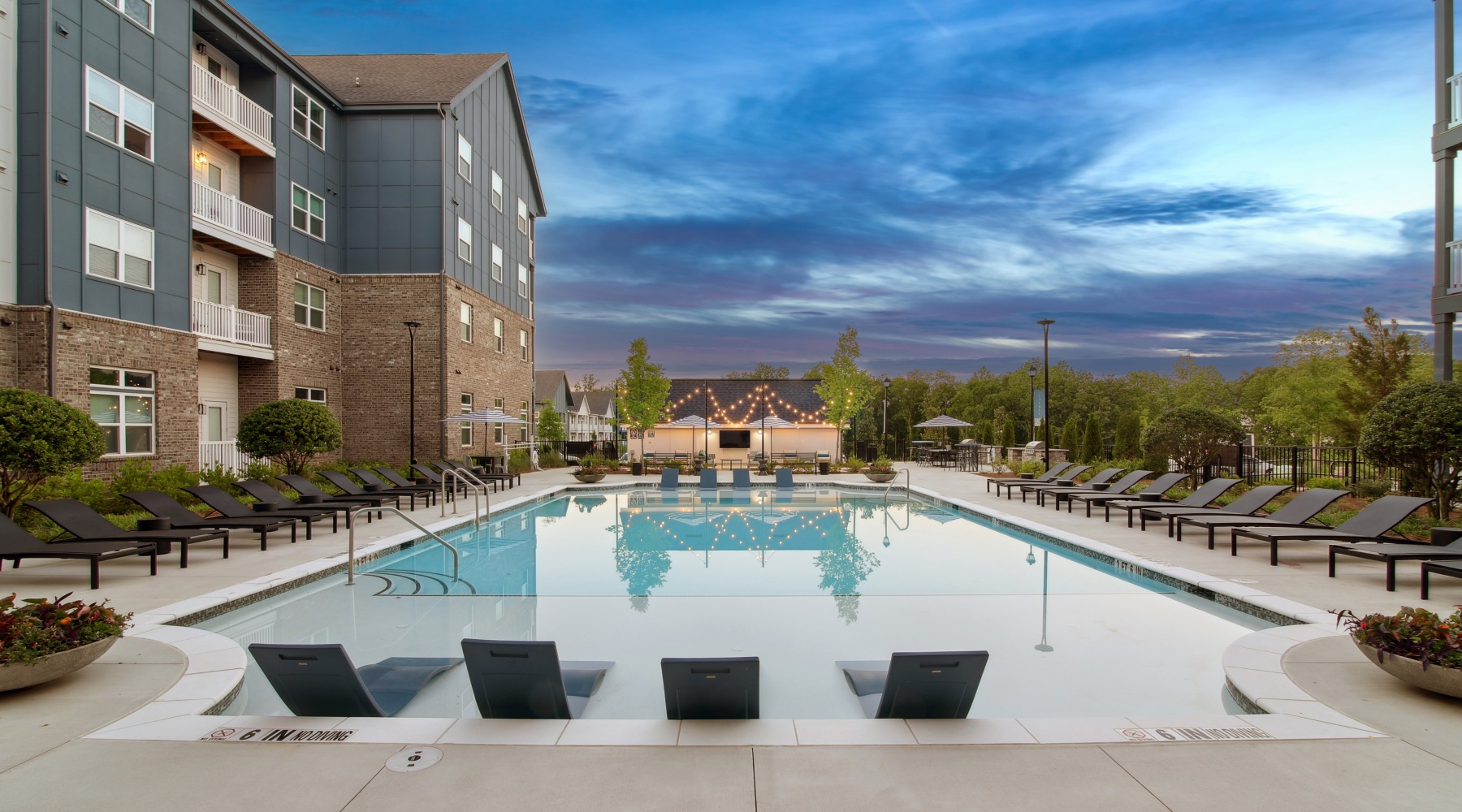 pool at dusk with seating pool at dusk with seating